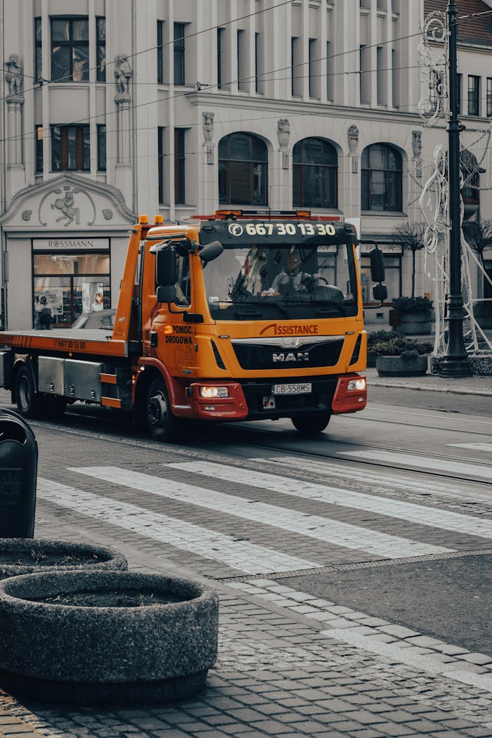 Services-01 Tow truck driving on a pedestrian lane in downtown Bydgoszcz, Poland.